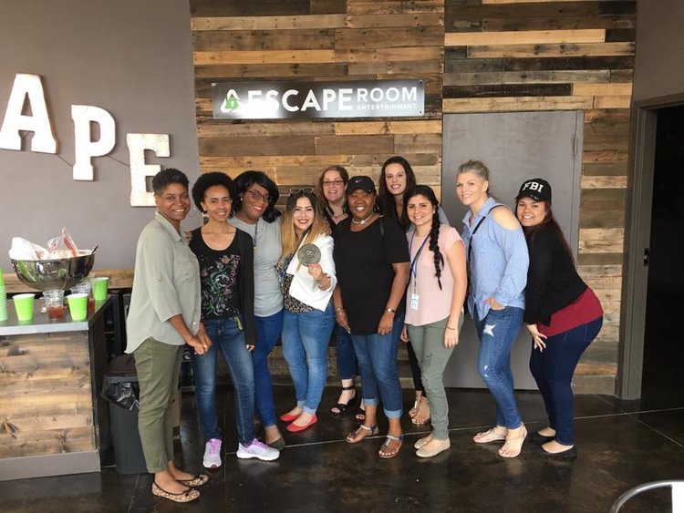 A team gathered together in the lobby before their escape room game